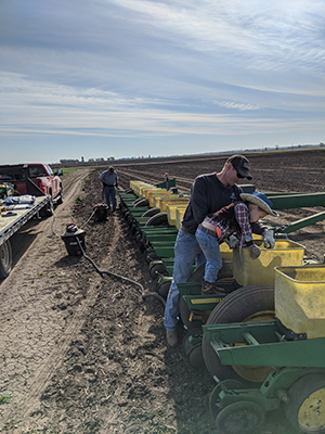 3 generations loading a planter